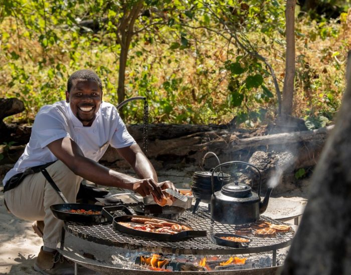 Botswana-Nxabega-Under-Canvas-main-guest-area-boma-chef-breakfast-food-4