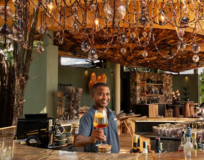 Tanzania-Grumeti-Serengeti-River-Lodge-Guest-Area-barmen-with-cocktail