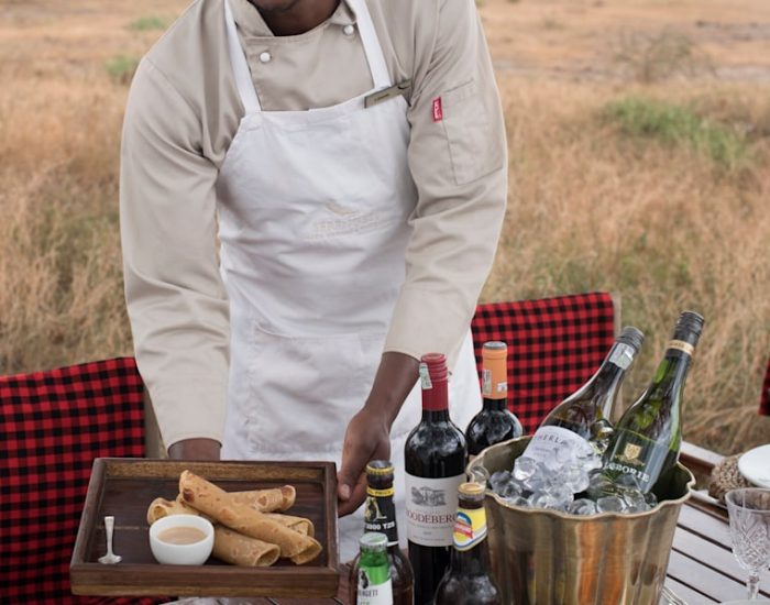 Tanzania-Serengeti-Under-Canvas-SUC-andBeyonder-chef-setting-up-dinner-