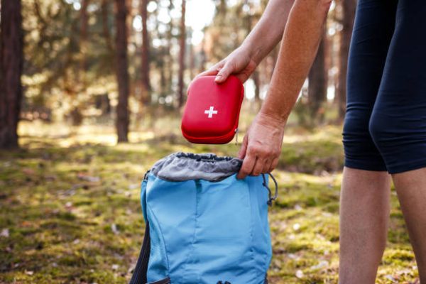 A traveler with a medical kit or mosquito net
